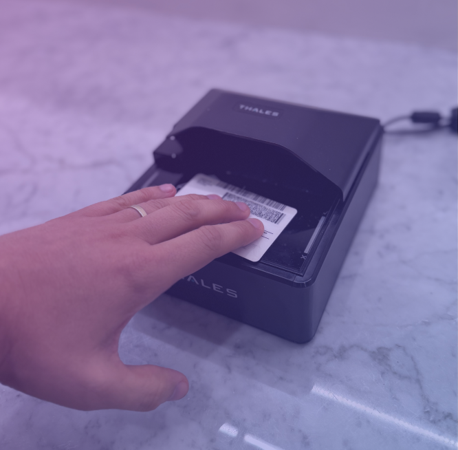 Driver's license being scanned on a front desk ID scanner