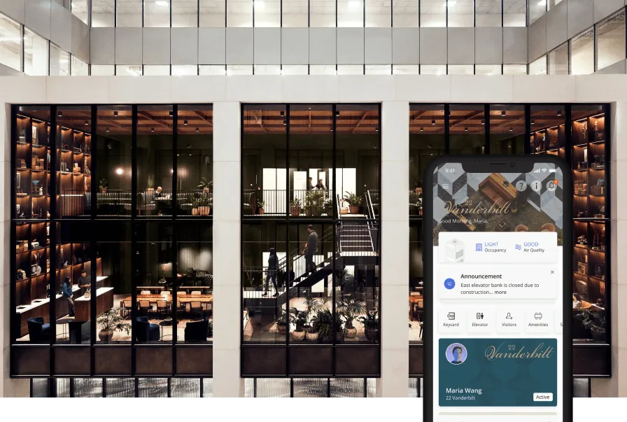 A Manhattan office tower atrium at night with a tenant tapping in on a mobile app