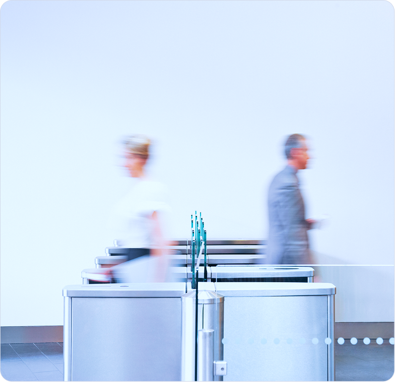 Modern office lobby with people moving through turnstiles