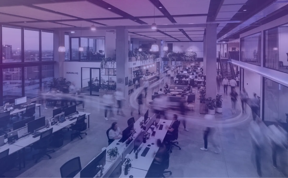 Time-lapse of a busy modern workplace showing people moving through the office